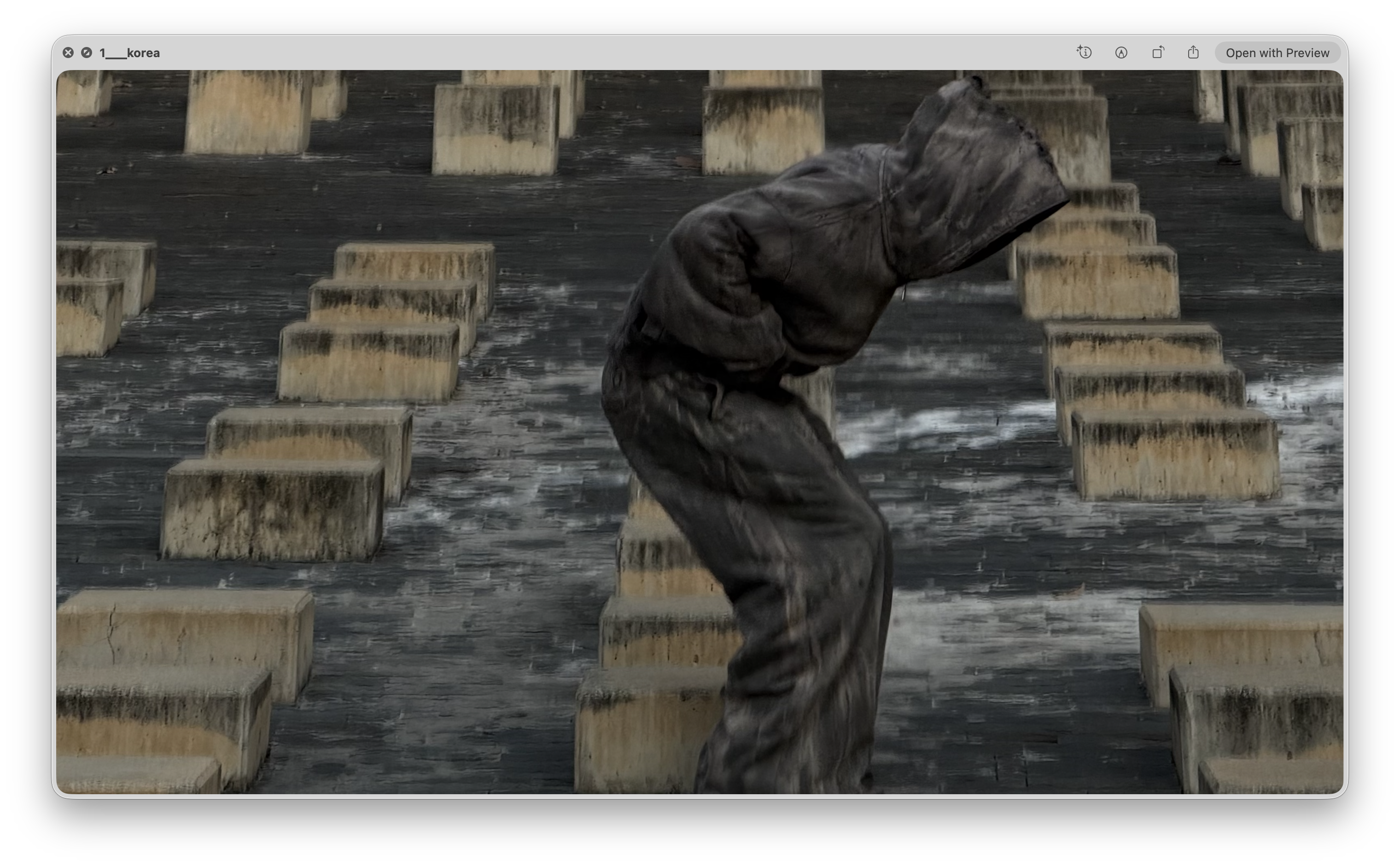 Academy by Aris hooded apparel among concrete blocks, first pose
