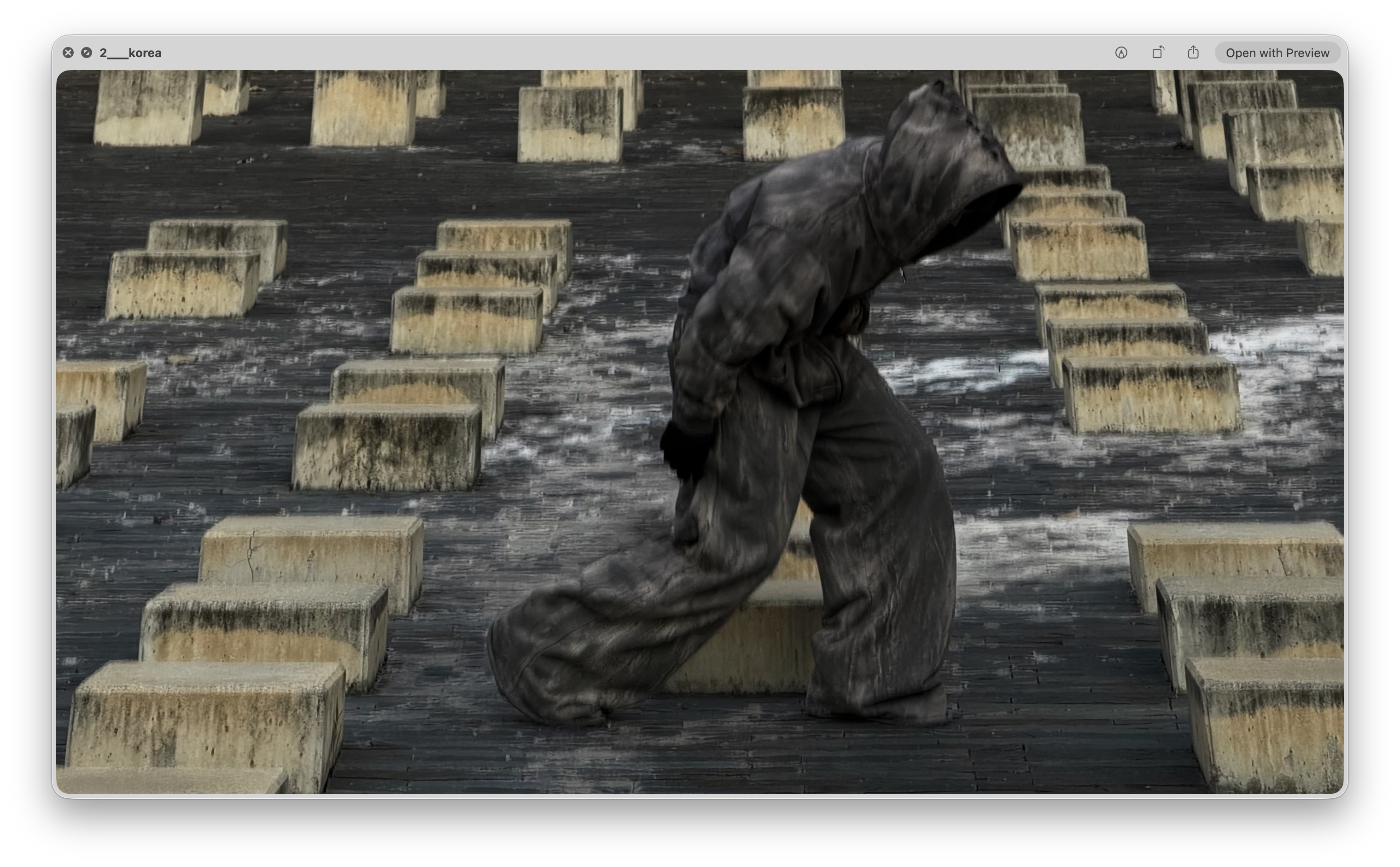 Academy by Aris hooded apparel among concrete blocks, second pose