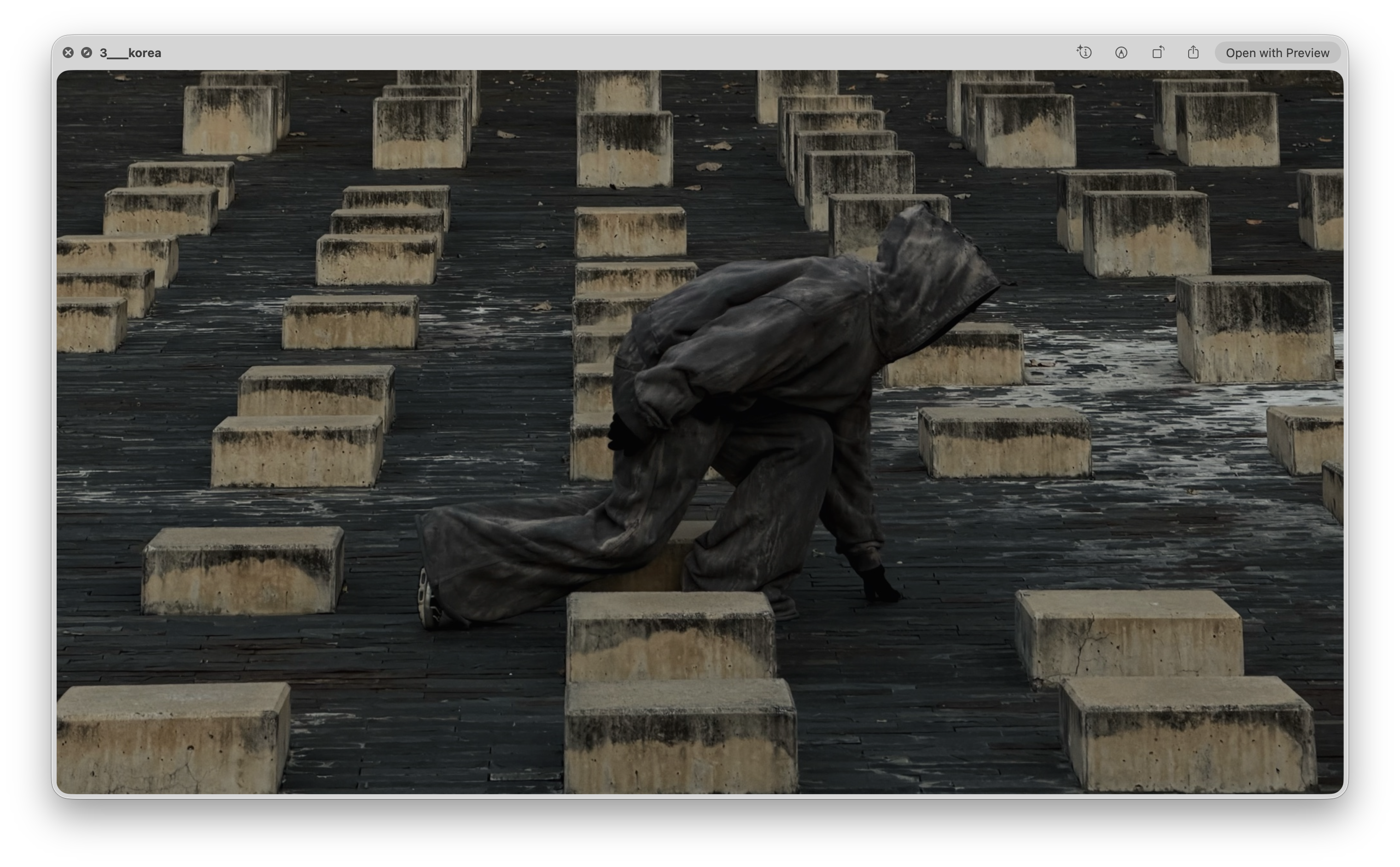Academy by Aris hooded apparel among concrete blocks, third pose